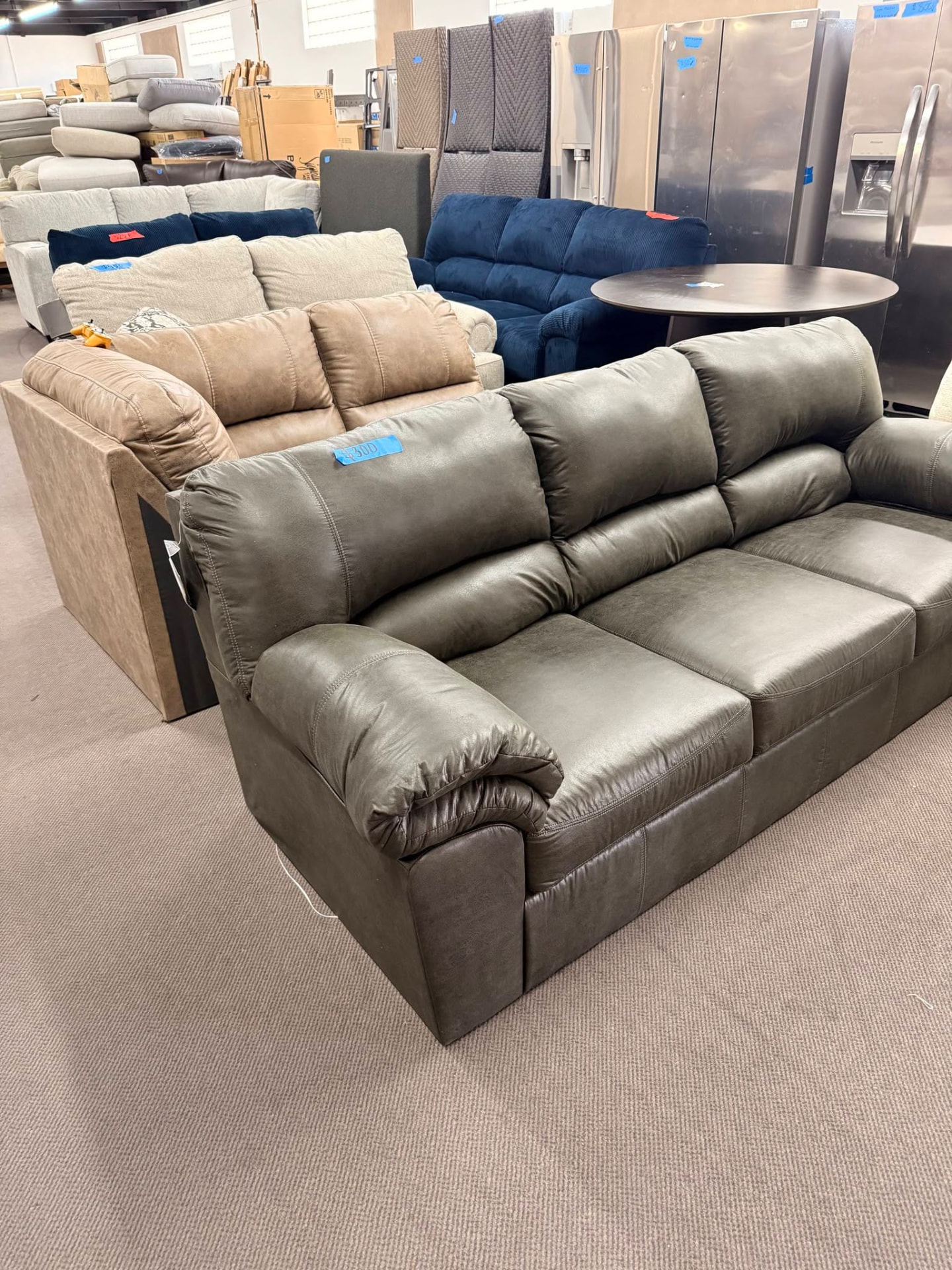Rows of leather and fabric sofas on the showroom floor