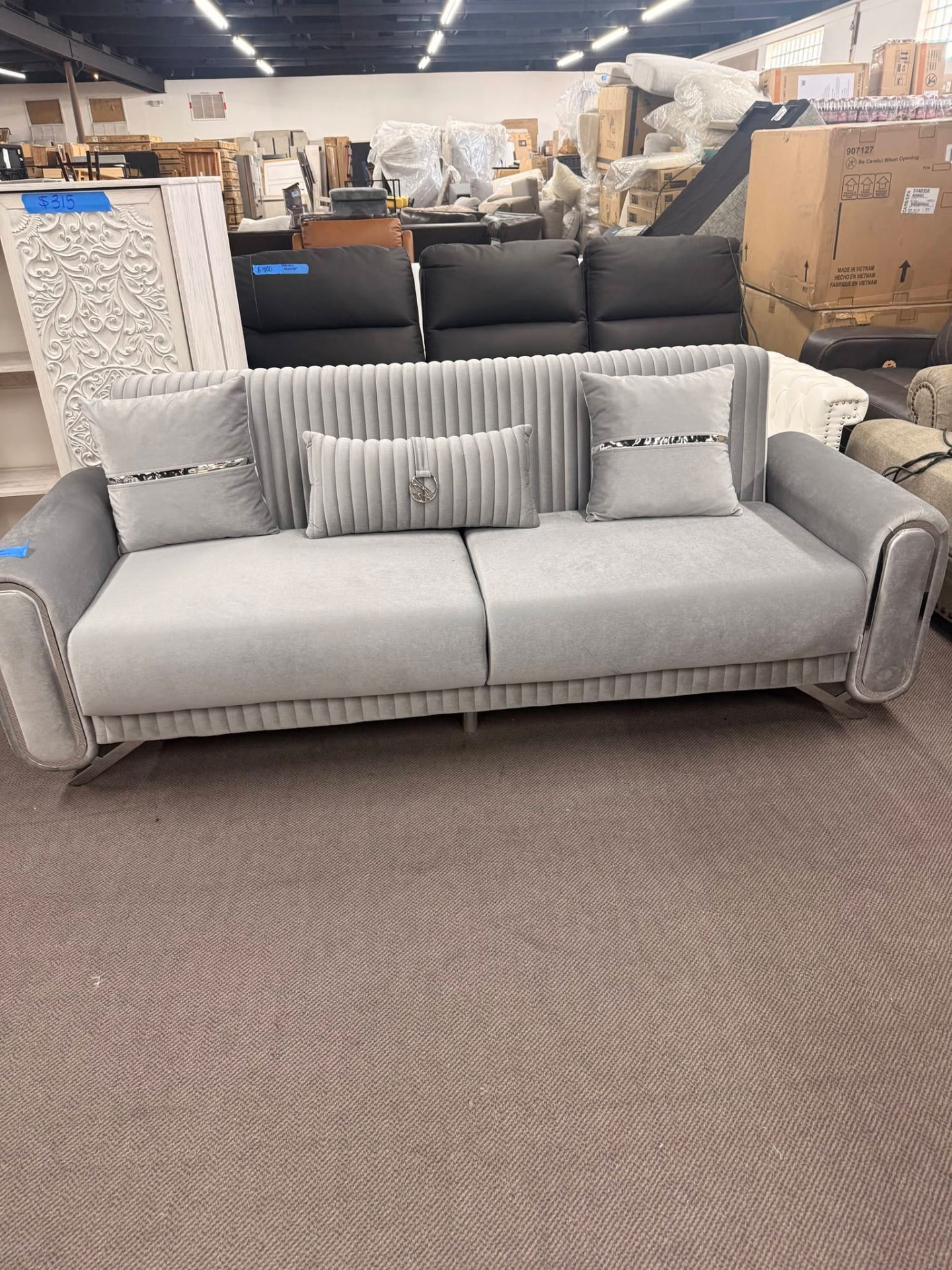 Gray channel-tufted modern sofa with pillows