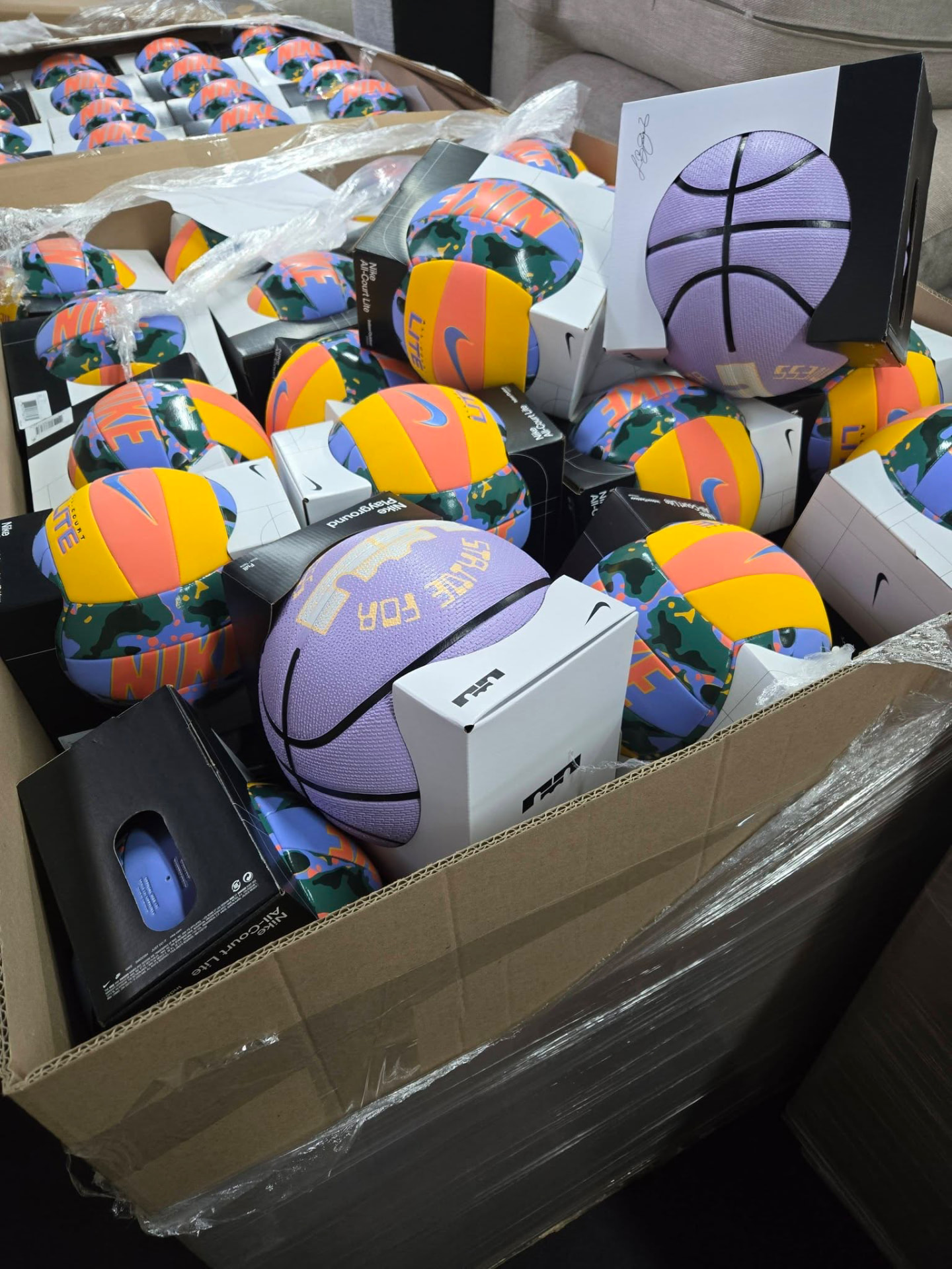 Case of new Nike basketballs still in packaging